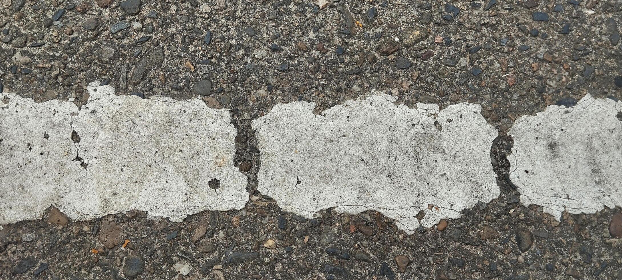 a close up of a road with white paint on it photo