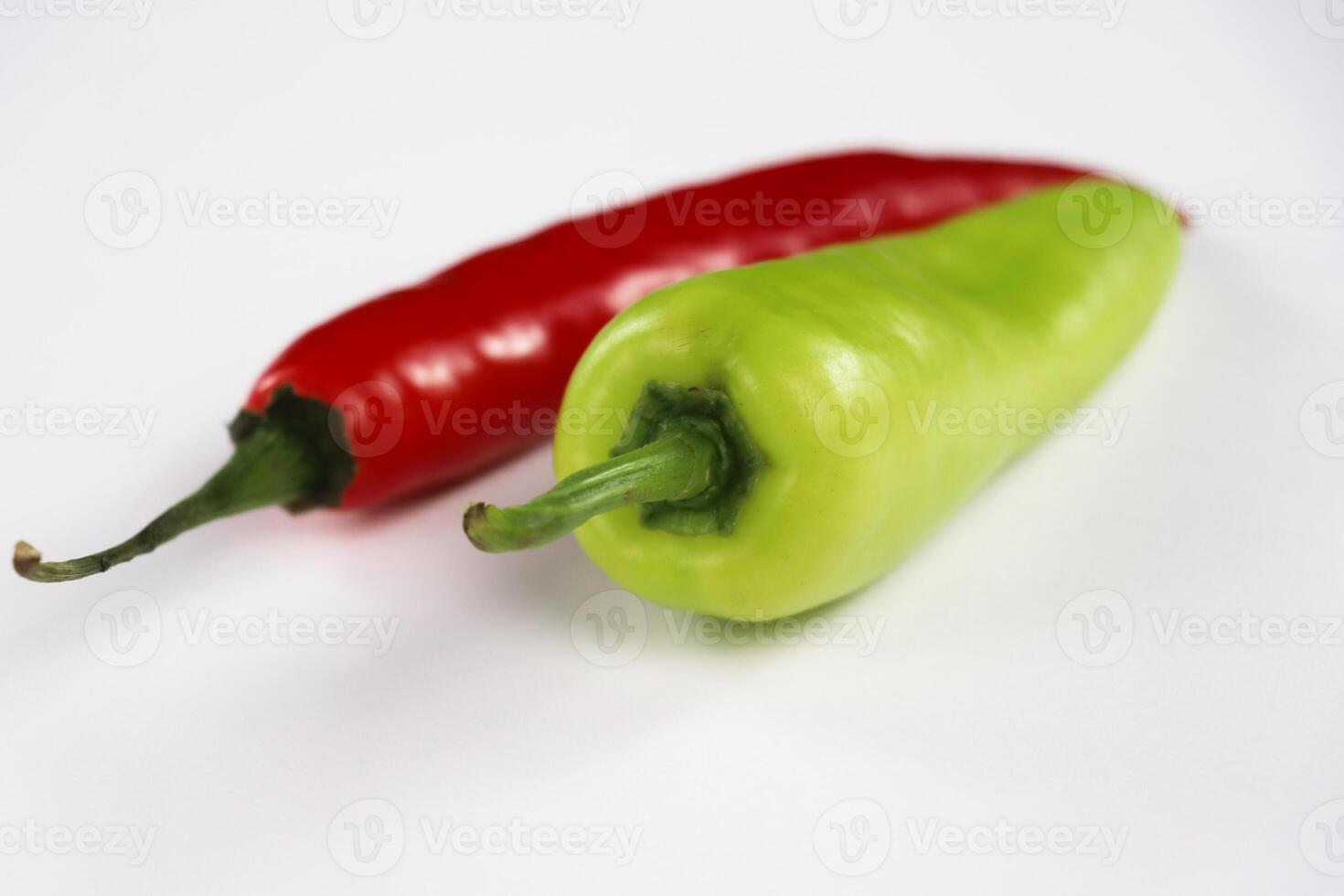 Close-Up of a Green Banana Pepper and a Red Chili Pepper photo