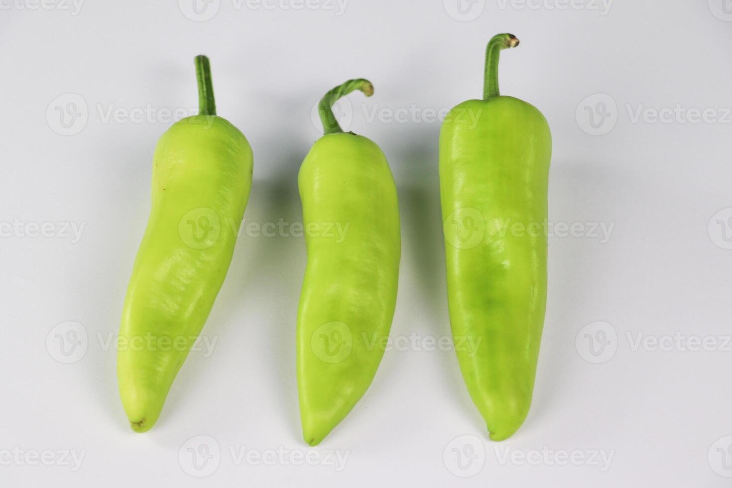 Three Fresh Green Peppers in a Row photo