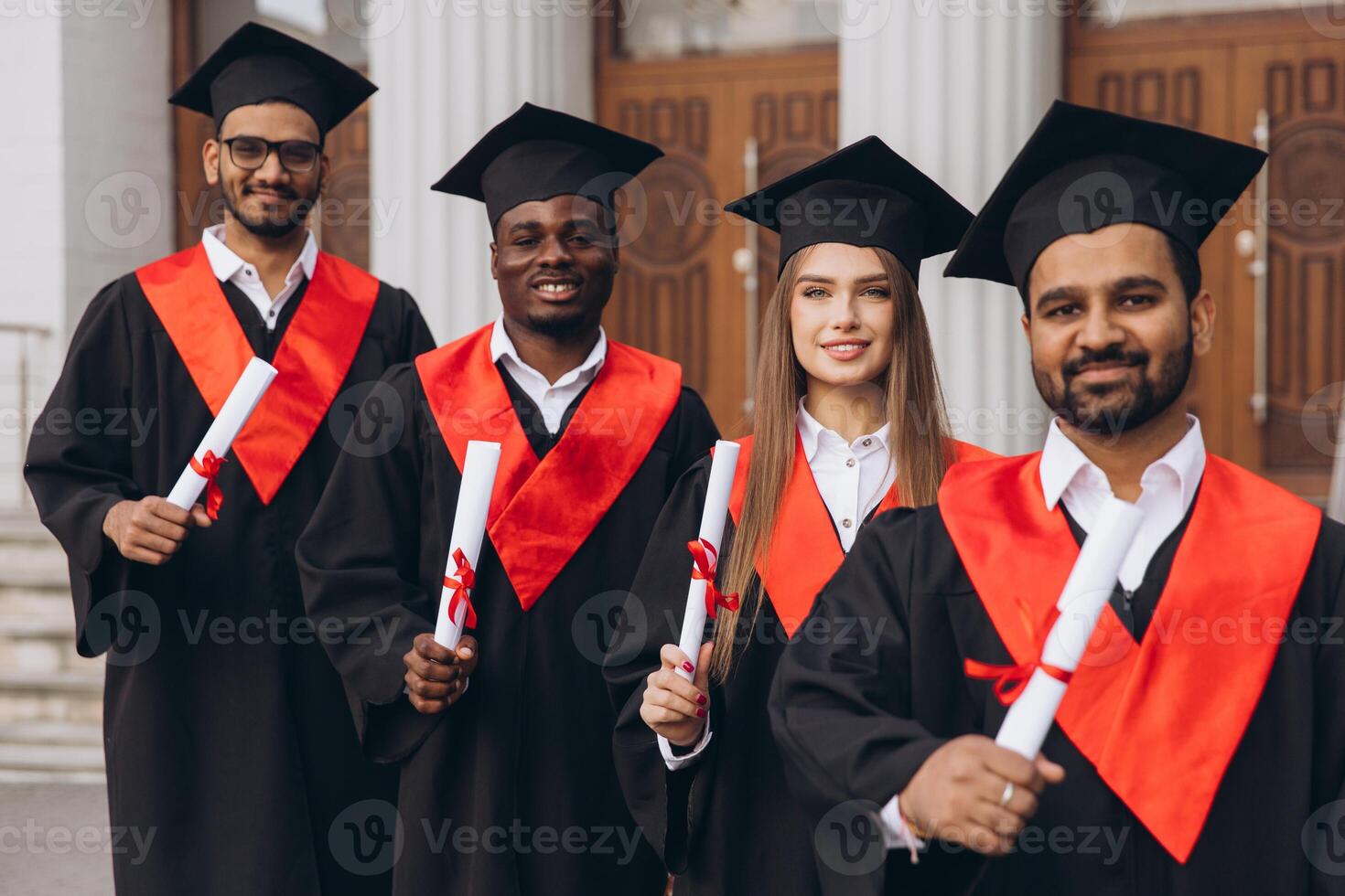 Diverse Group of Happy Graduates in Caps and Gowns Celebrating Success in Front of University Building photo