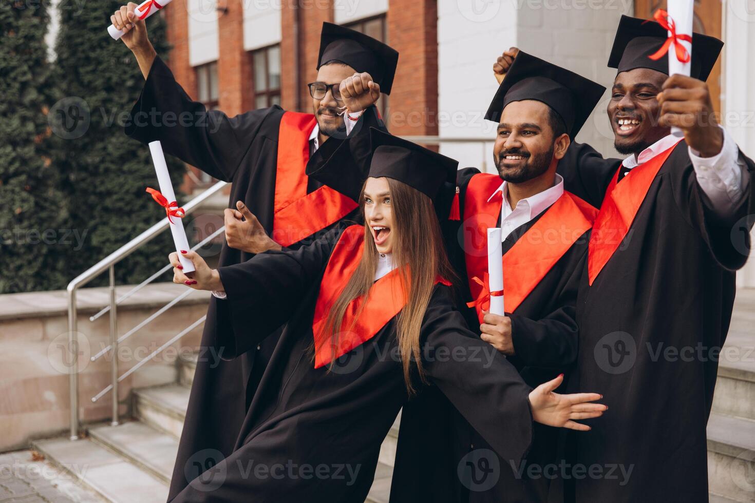Joyful Group of Graduates Celebrating Success in Academic Achievement Outdoors in Caps and Gowns photo
