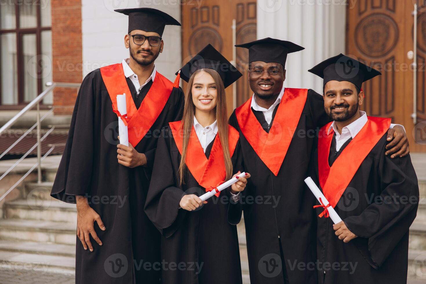Group Of Happy Graduates Celebrating Success In Academic Graduation Ceremony Outdoors photo