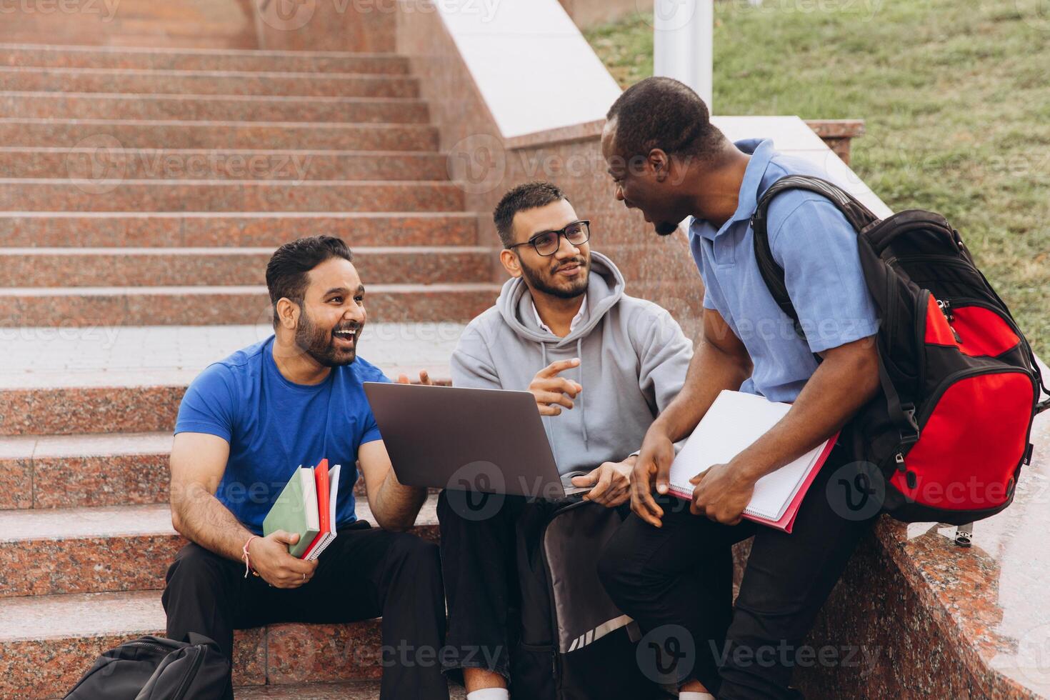 Diverse Group of Students Studying Together Outdoors on College Campus Steps photo