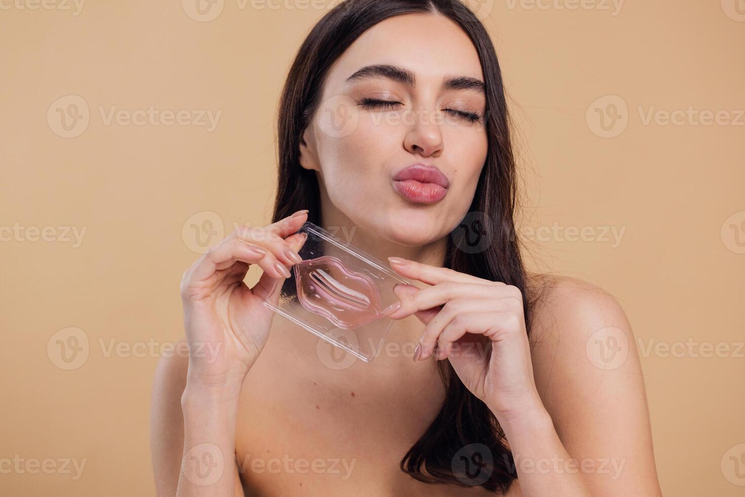 Happy Woman holding collagen lip mask for dry and chapped lips photo