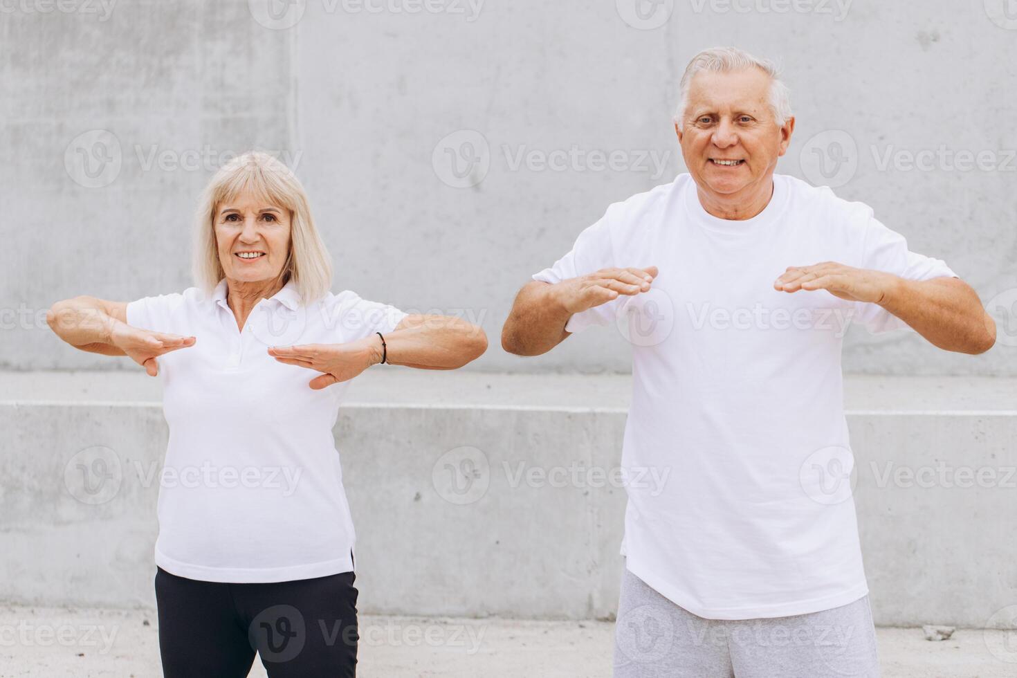 Elderly Couple Exercising Outdoors in Casual Sportswear for Fitness and Health photo
