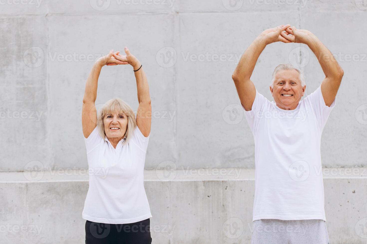 Senior Couple Exercising Outdoors with Stretching Exercises for a Healthy Lifestyle photo