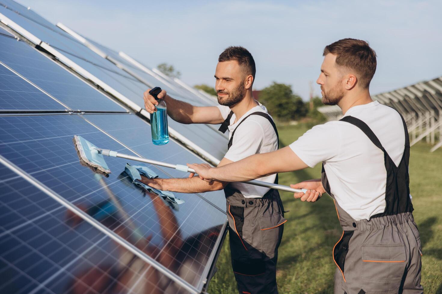 Labor working on cleaning solar panel at solar power plant, Professional cleaning, Solar panels. photo