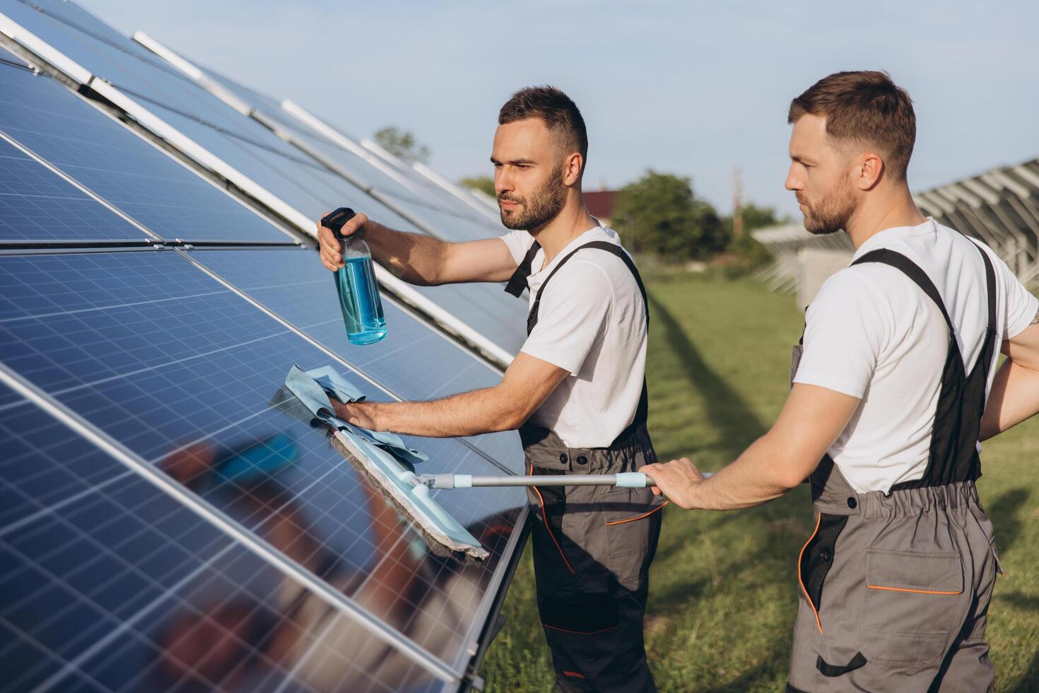 Labor working on cleaning solar panel at solar power plant, Professional cleaning, Solar panels. photo