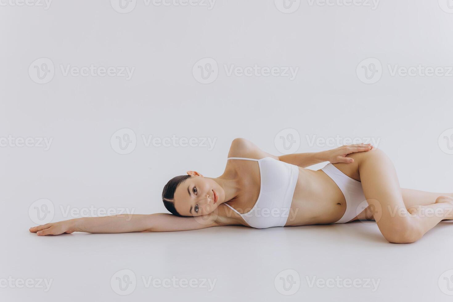 Body Beauty, Slim Woman in White Underwear Lying Down on Back, Happy Dreaming Girl Isolated over White Background with Copy Space, Mock-up photo