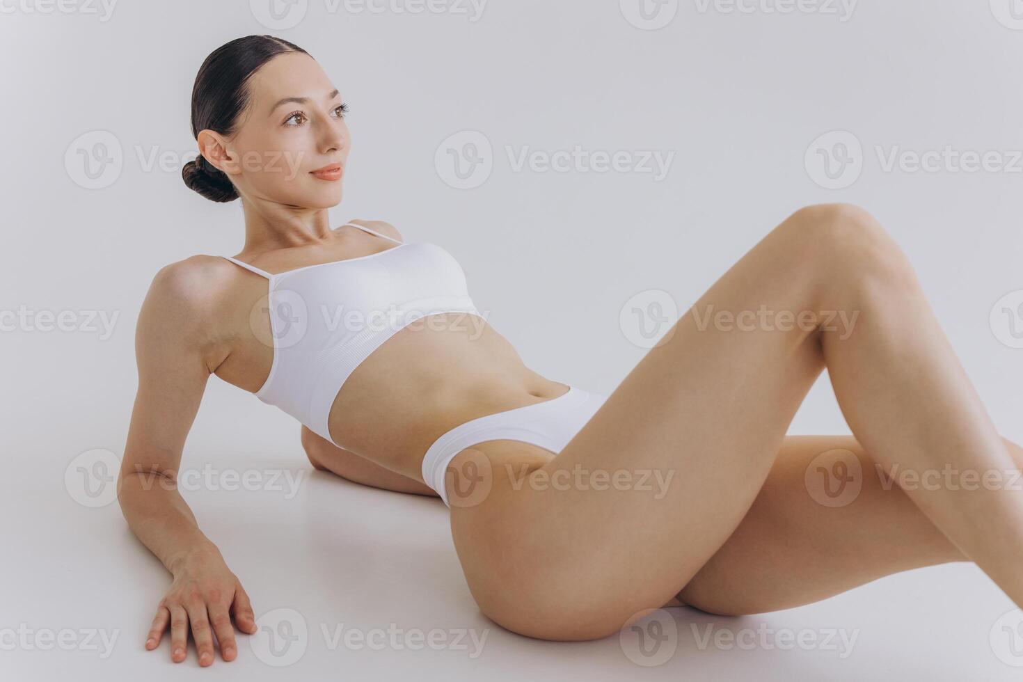 Body Beauty, Slim Woman in White Underwear Lying Down on Back, Happy Dreaming Girl Isolated over White Background with Copy Space, Mock-up photo