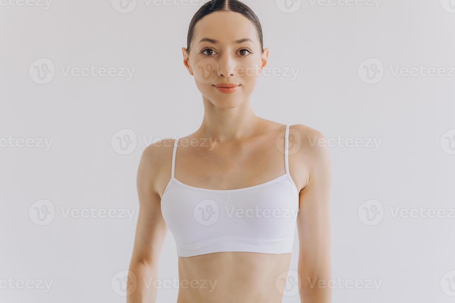 Portrait of beautiful woman with slim body in underwear posing in the white studio background with copy space, mock-up photo