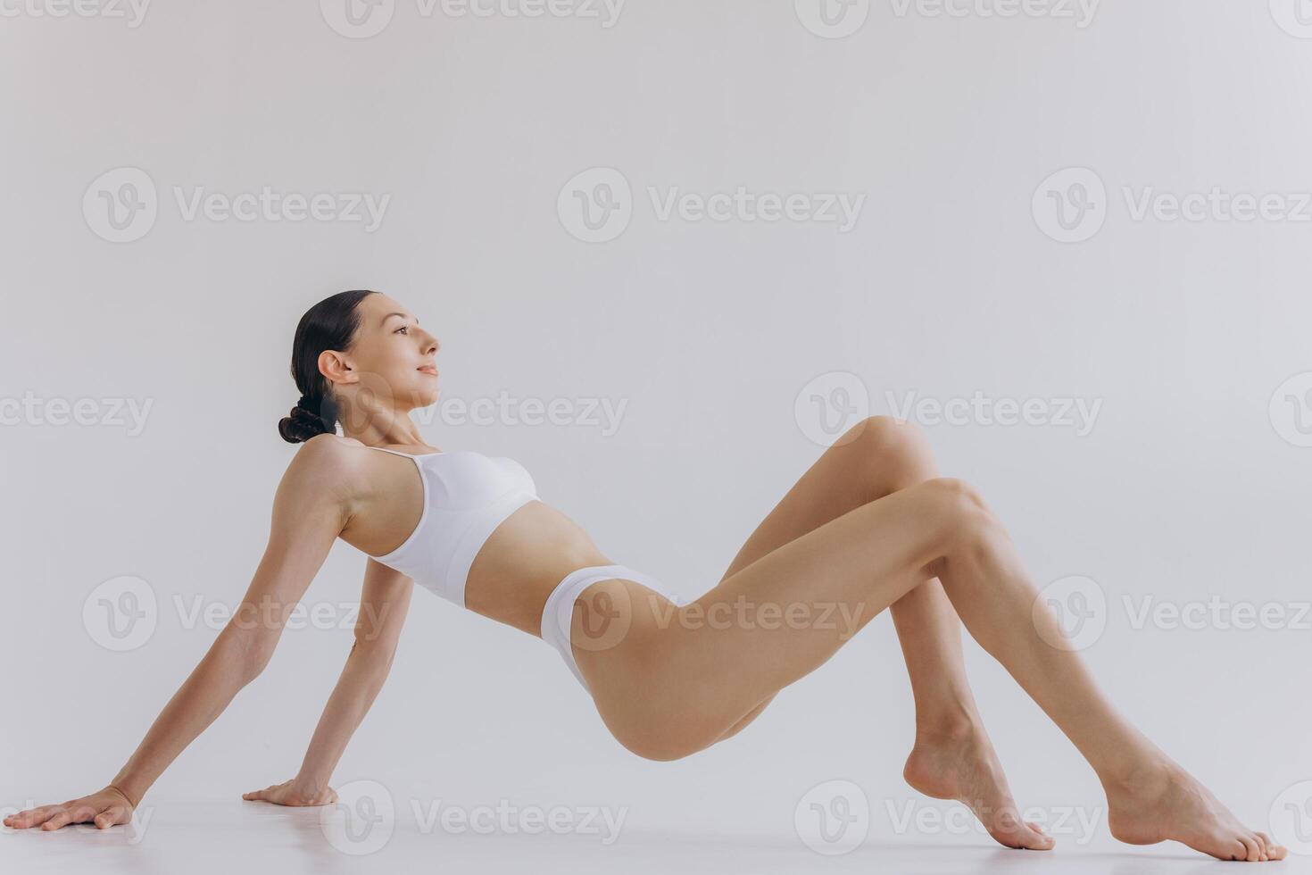 Fit and sporty beautiful woman with perfect shape. Girl in white underwear on the floor. Healthy lifestyle, sport, health care, nutrition and diet concept photo
