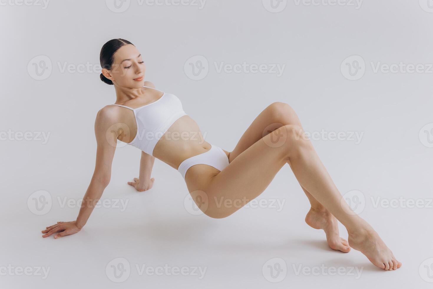 Body Beauty, Slim Woman in White Underwear Lying Down on Back, Happy Dreaming Girl Isolated over White Background with Copy Space, Mock-up photo