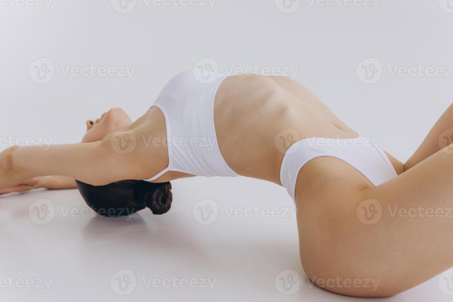 Body Beauty, Slim Woman in White Underwear Lying Down on Back, Happy Dreaming Girl Isolated over White Background with Copy Space, Mock-up photo