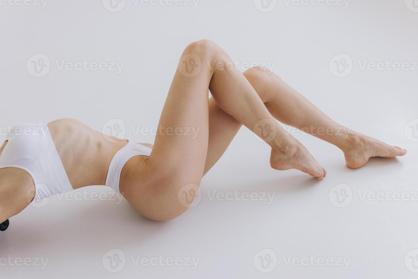 Part of Ideal Female Body Legs, Slim Woman in White Underwear Lying Down on Back, Happy Girl Isolated over White Background with Copy Space, Mock-up. Beauty photo