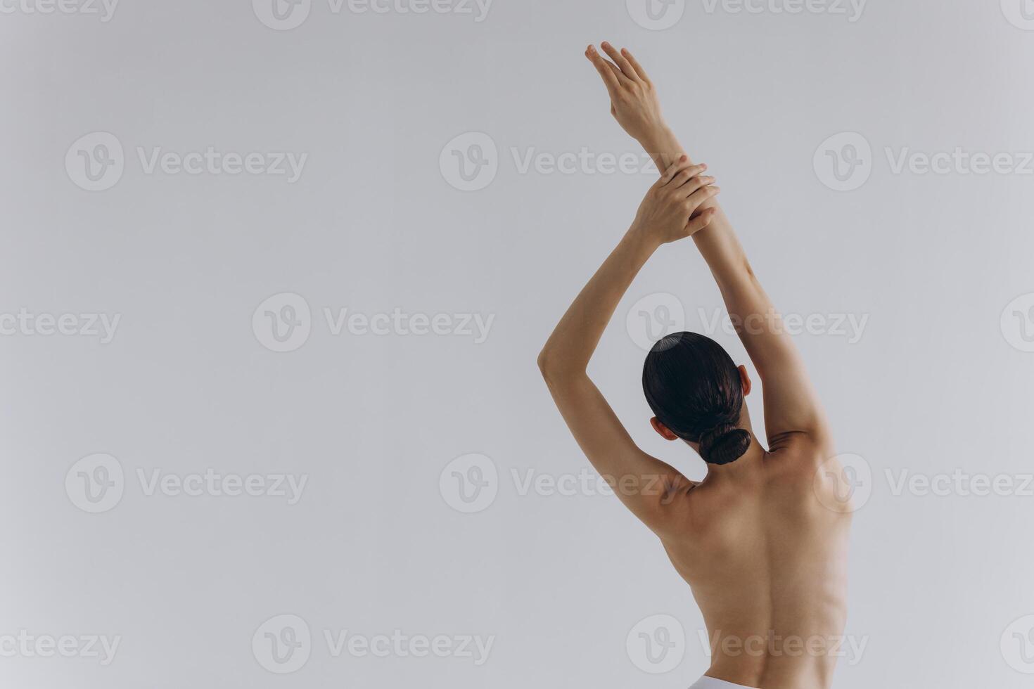 Cropped back rear view young sexy lady woman with slim body perfect skin wearing nude top bra lingerie stand hold hands on thighs isolated on white background. Lifestyle diet fit concept photo