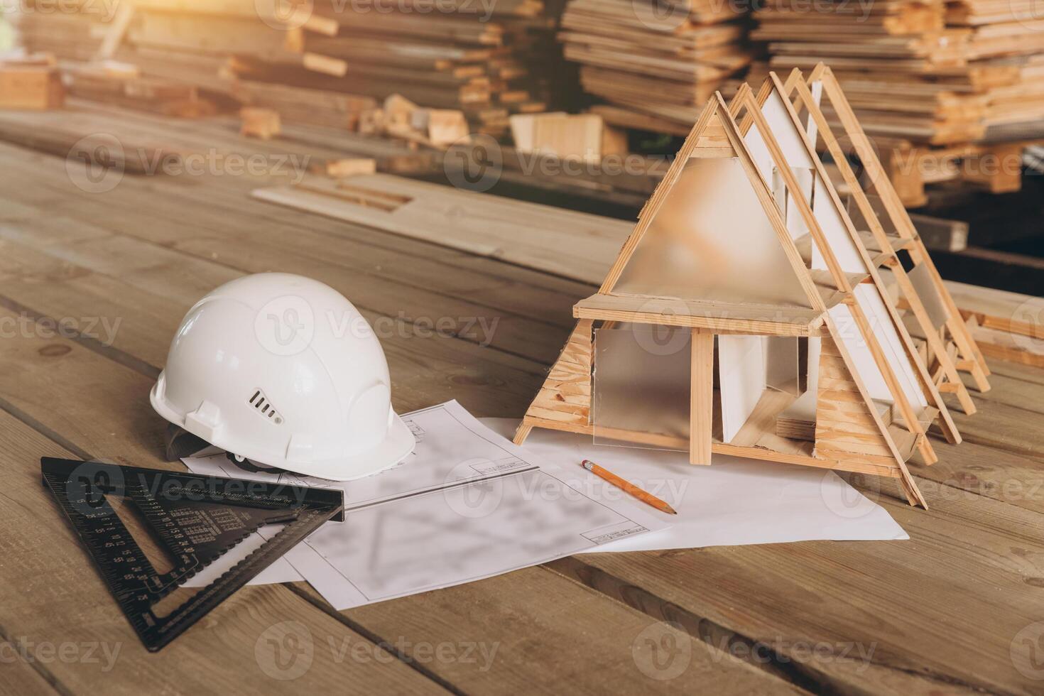 Top view mock -up architectural office desk with copy space, wooden floor with miniature model of house, white helmet construction, pencil, ruler and paper roll, copy space, mock up photo