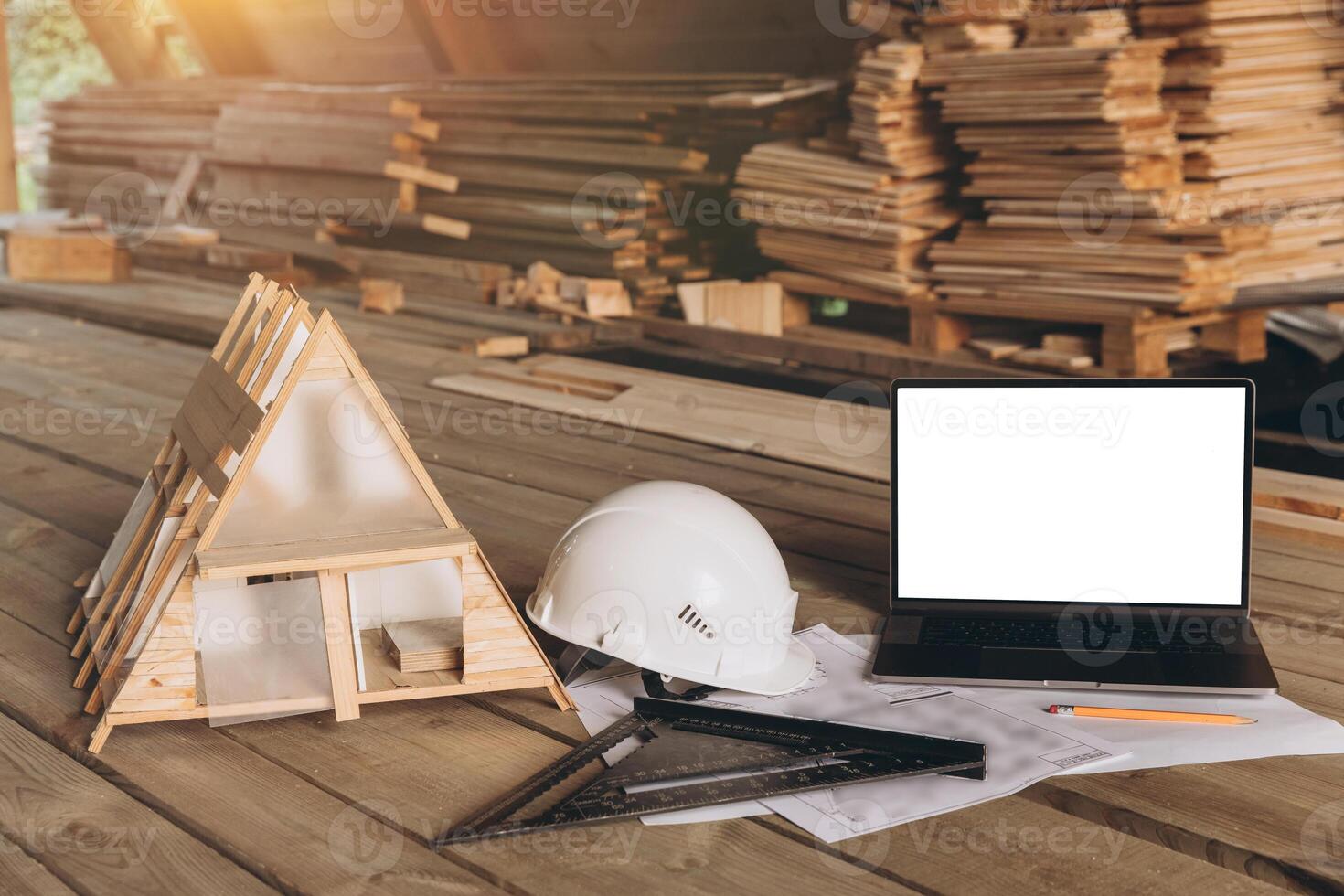 Top view mock -up architectural office desk with copy space, wooden floor with laptop, miniature model of house, white helmet construction, pencil, ruler and paper roll, copy space, mock up photo