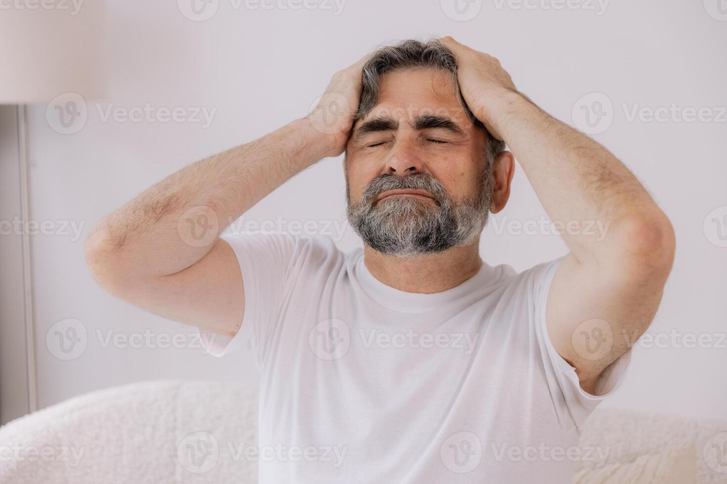 Home, senior man and headache on sofa for stress, emotional conflict and temporal vertigo. Living room, couch and old person with pain, migraine and anxiety due overthinking in retirement in house photo