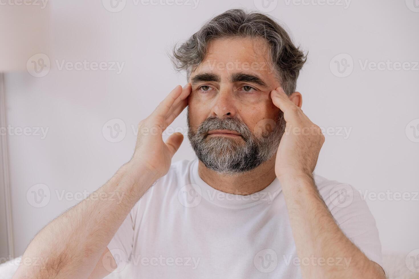 Home, senior man and headache on sofa for stress, emotional conflict and temporal vertigo. Living room, couch and old person with pain, migraine and anxiety due overthinking in retirement in house photo