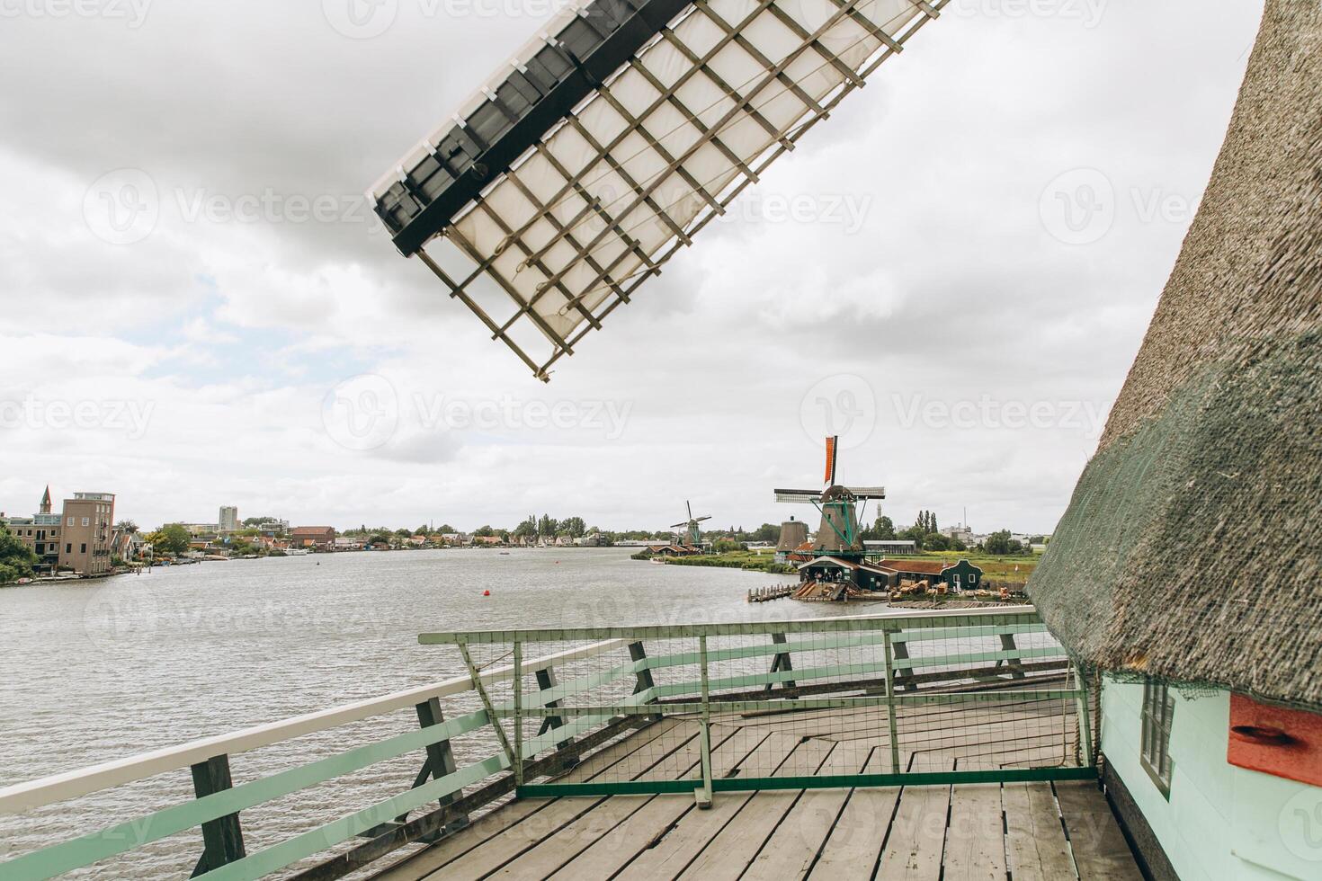 Rural landscape with windmill in Zaanse Schans. Holland, Netherlands. Authentic Zaandam mill. photo