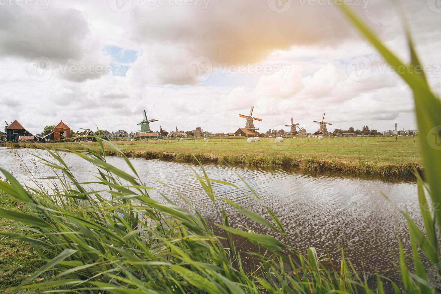 Rural landscape with windmill in Zaanse Schans. Holland, Netherlands. Authentic Zaandam mill. photo