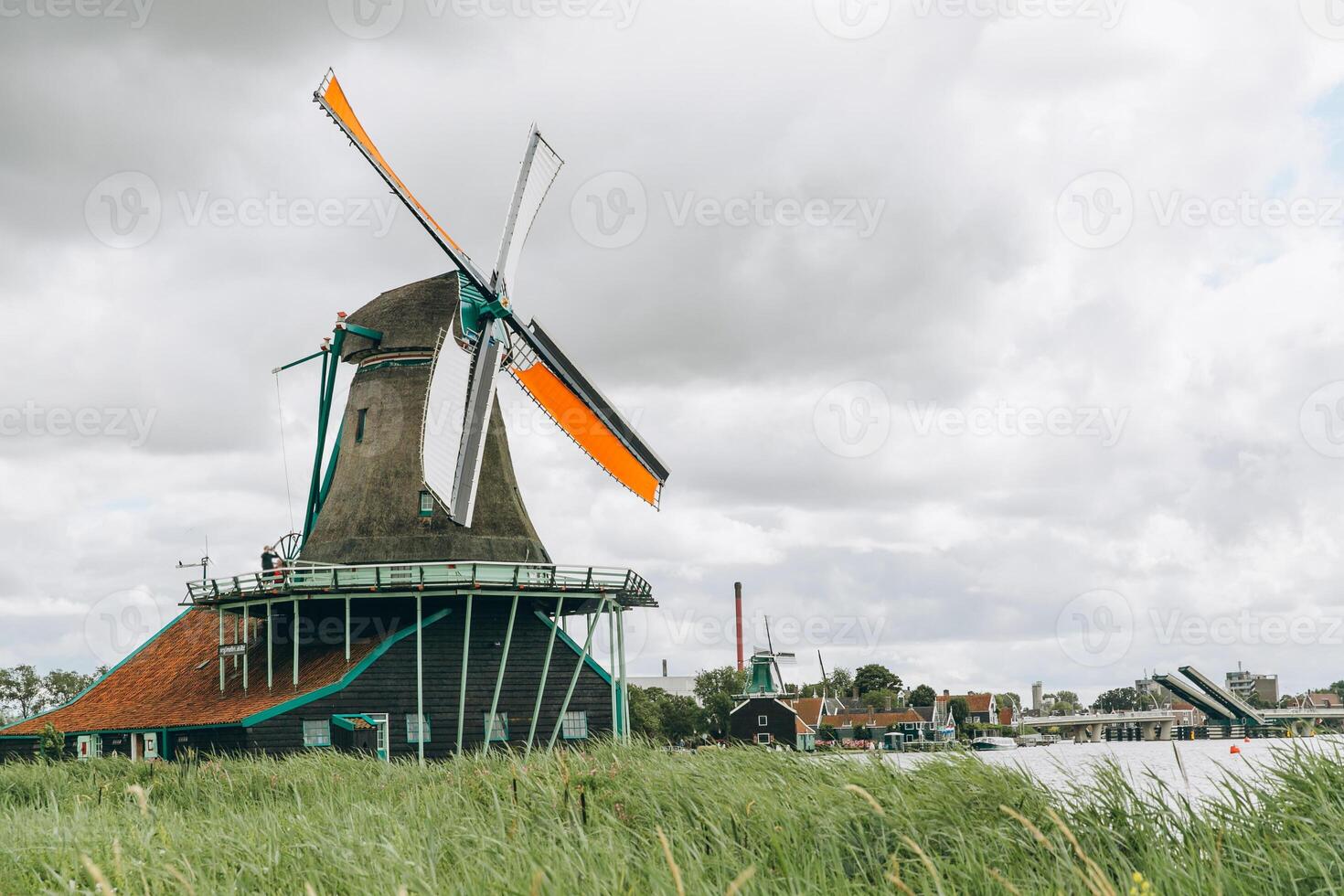 Rural landscape with windmill in Zaanse Schans. Holland, Netherlands. Authentic Zaandam mill. photo