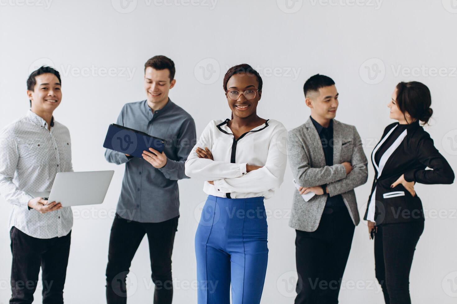 Group of multicultural young executive people standing and busy using smartphones for work in the office. Social media technology and online business with teenager lifestyle concept photo