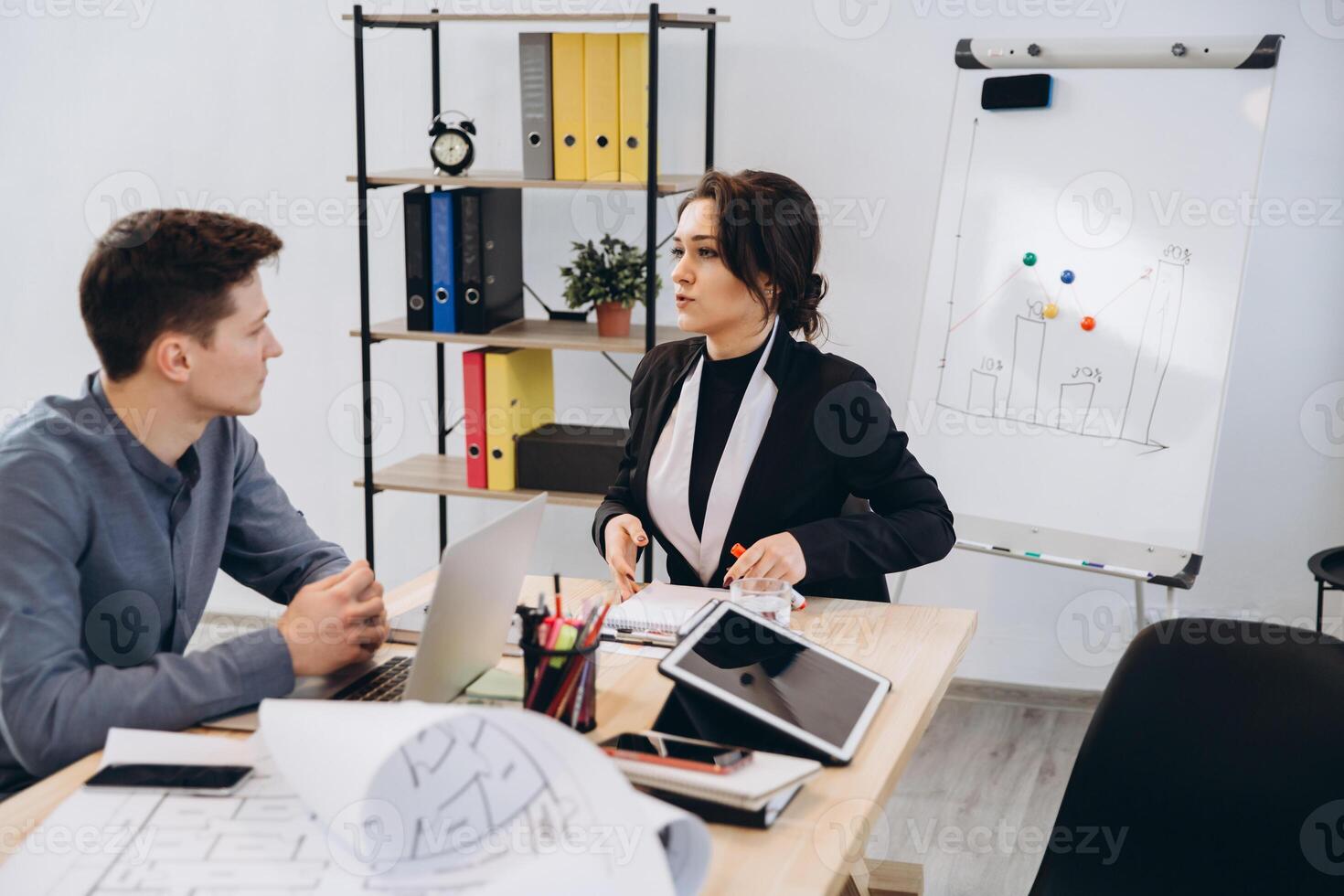 Young man having an interview or business meeting with employer. Employer examining in a modern office interior photo