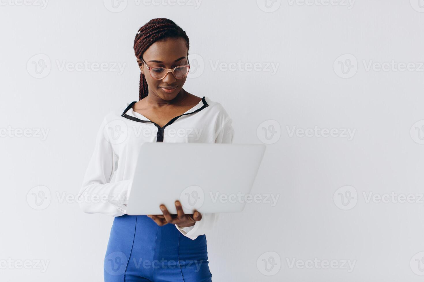 An isolated shot of a black businesswoman holding a laptop photo