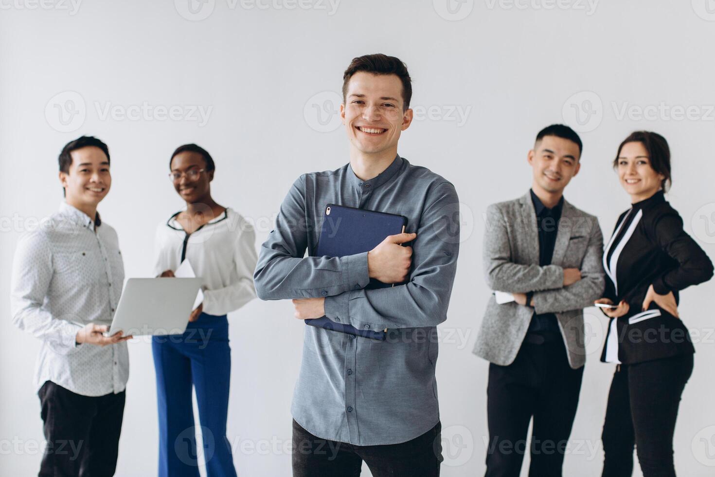 Group of multicultural young executive people standing and busy using smartphones for work in the office. Social media technology and online business with teenager lifestyle concept photo