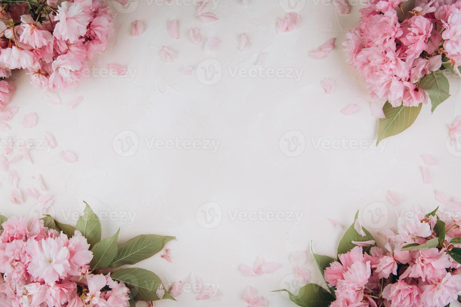 Sprigs of the sakura tree with flowers and petals on trendy marble background. Place for text. The concept of spring came. Top view. Flat lay photo