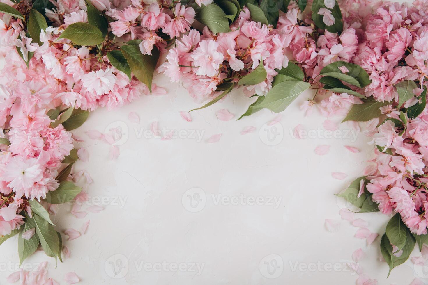 Sprigs of the sakura tree with flowers and petals on trendy marble background. Place for text. The concept of spring came. Top view. Flat lay photo