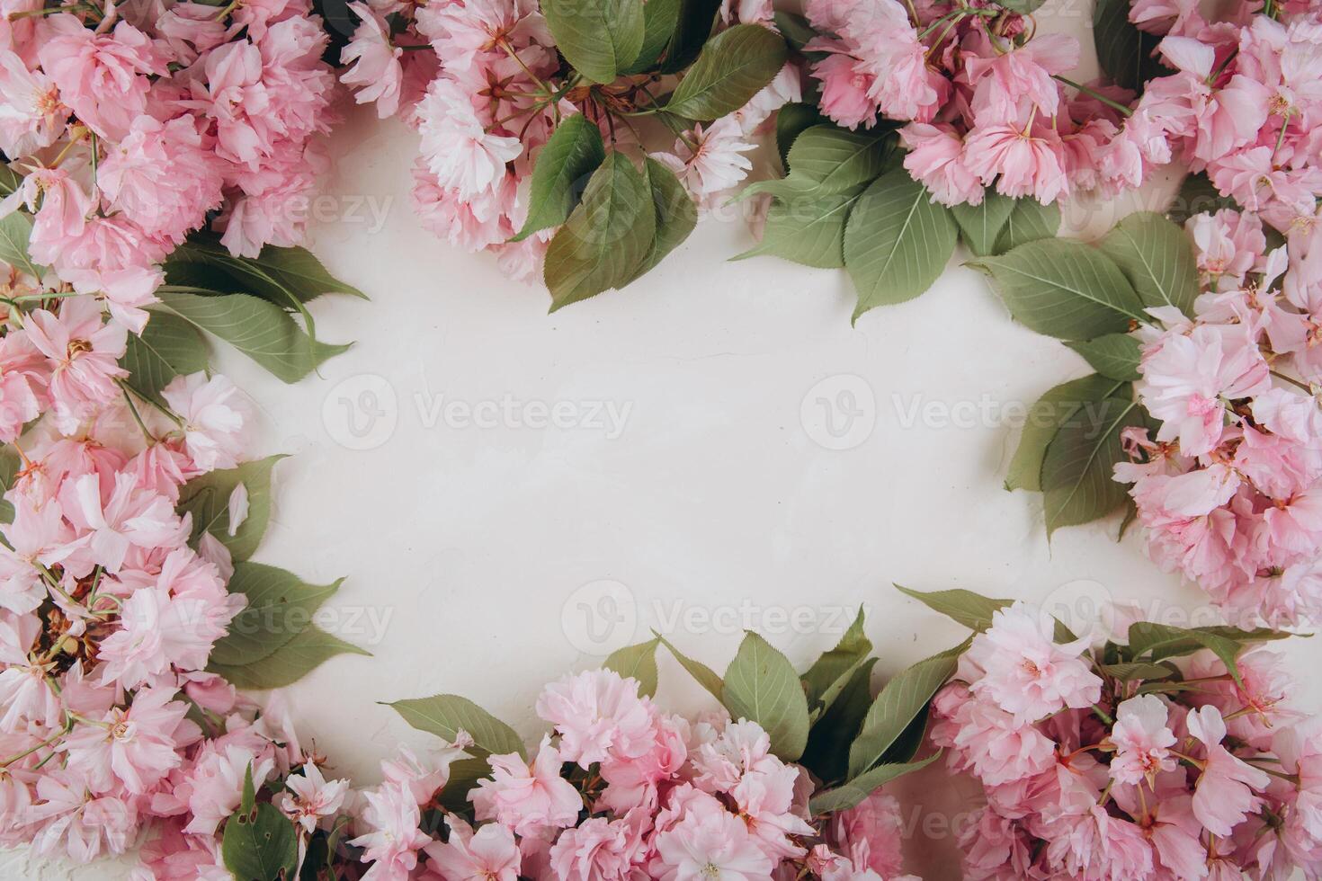 Sprigs of the sakura tree with flowers and petals on trendy marble background. Place for text. The concept of spring came. Top view. Flat lay photo