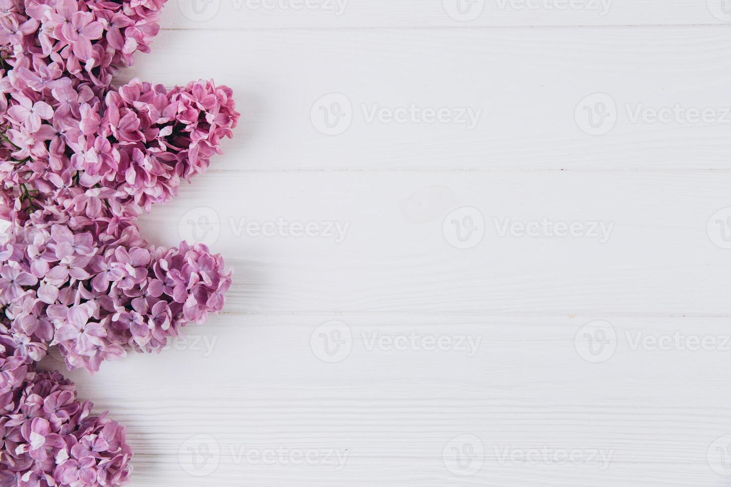 Floral pattern of a branch of lilac on a wooden white background. Top view. Flat lay. Spring concept. Copy space photo