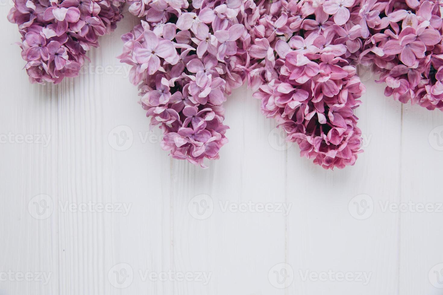 Floral pattern of a branch of lilac on a wooden white background. Top view. Flat lay. Spring concept. Copy space photo