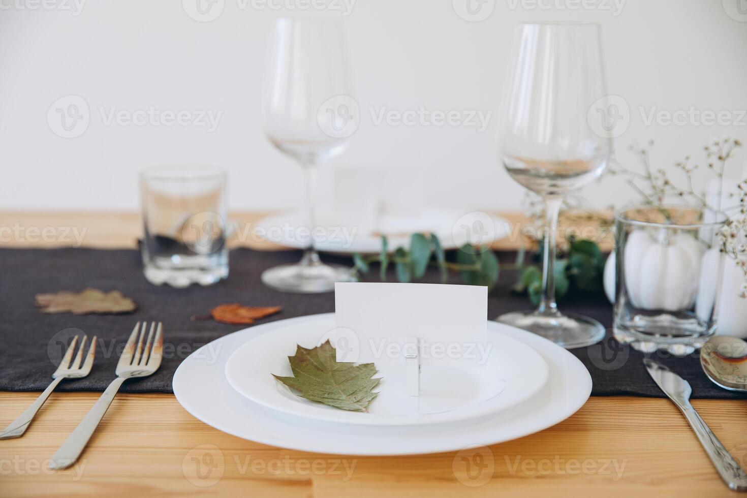 Thanksgiving table setting, tableware and decorations. Blank white postcard on table mockup. photo