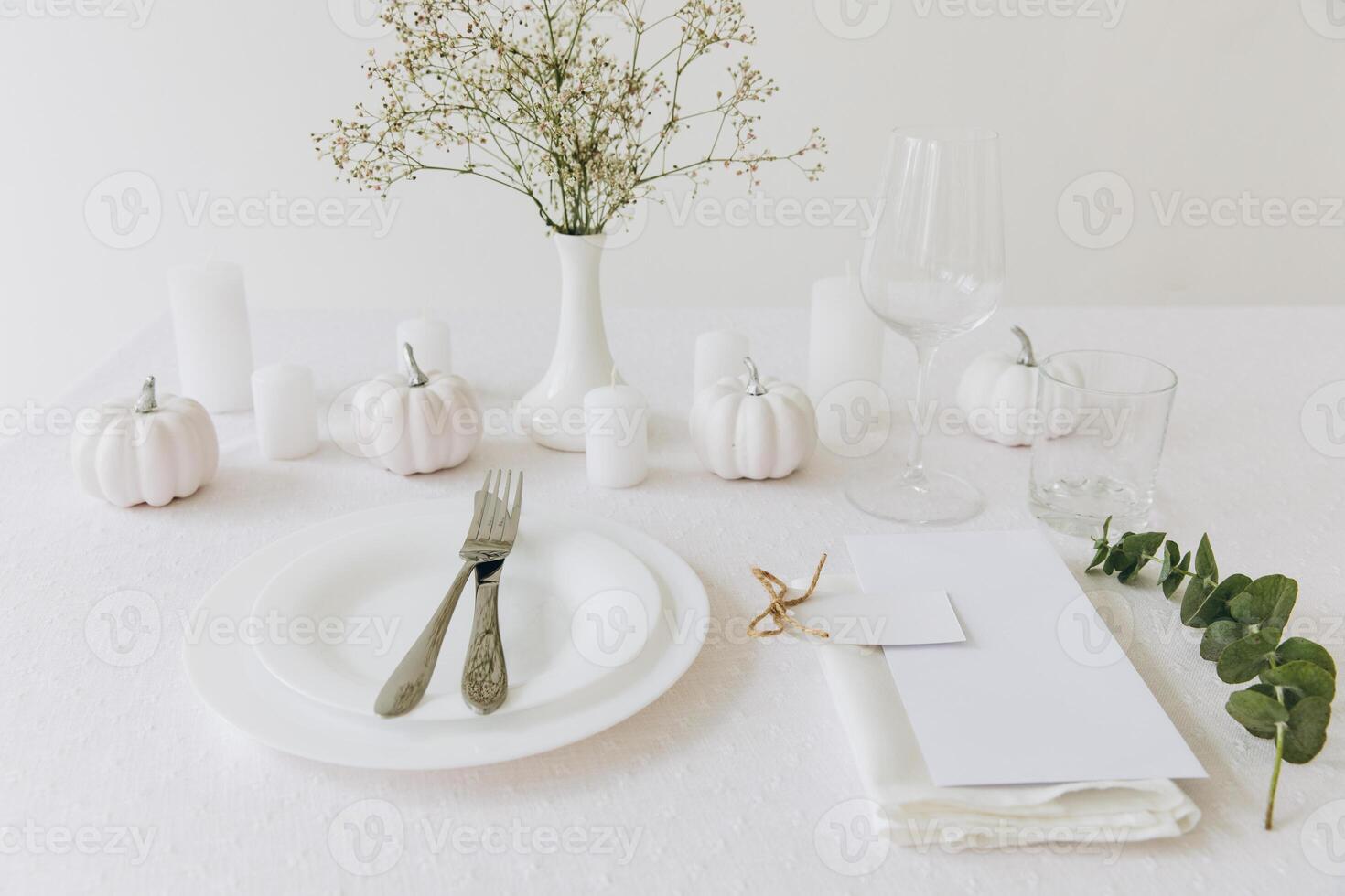 Thanksgiving table setting, tableware and decorations. Blank white postcard on table mockup. photo