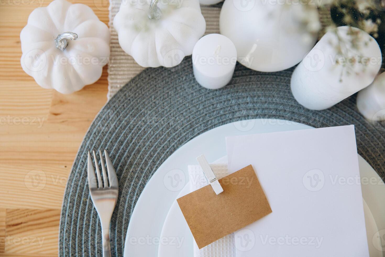 Thanksgiving table setting, tableware and decorations. Blank white postcard on table mockup. photo