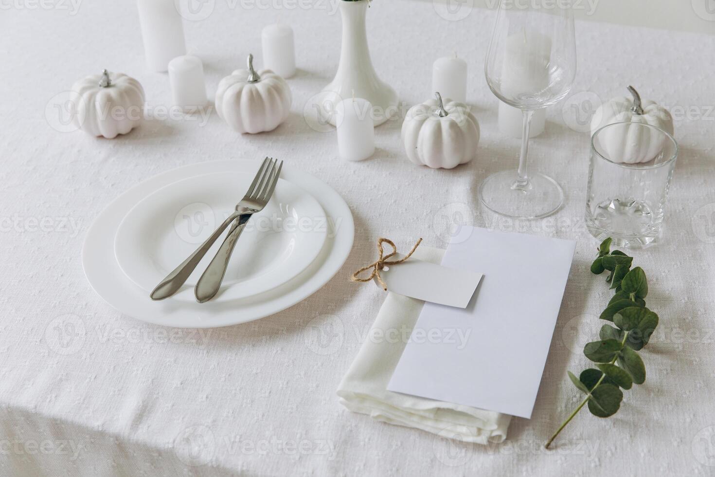 Thanksgiving table setting, tableware and decorations. Blank white postcard on table mockup. photo