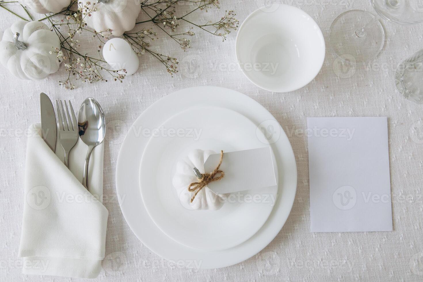 Thanksgiving table setting, tableware and decorations. Blank white postcard on table mockup, top view photo