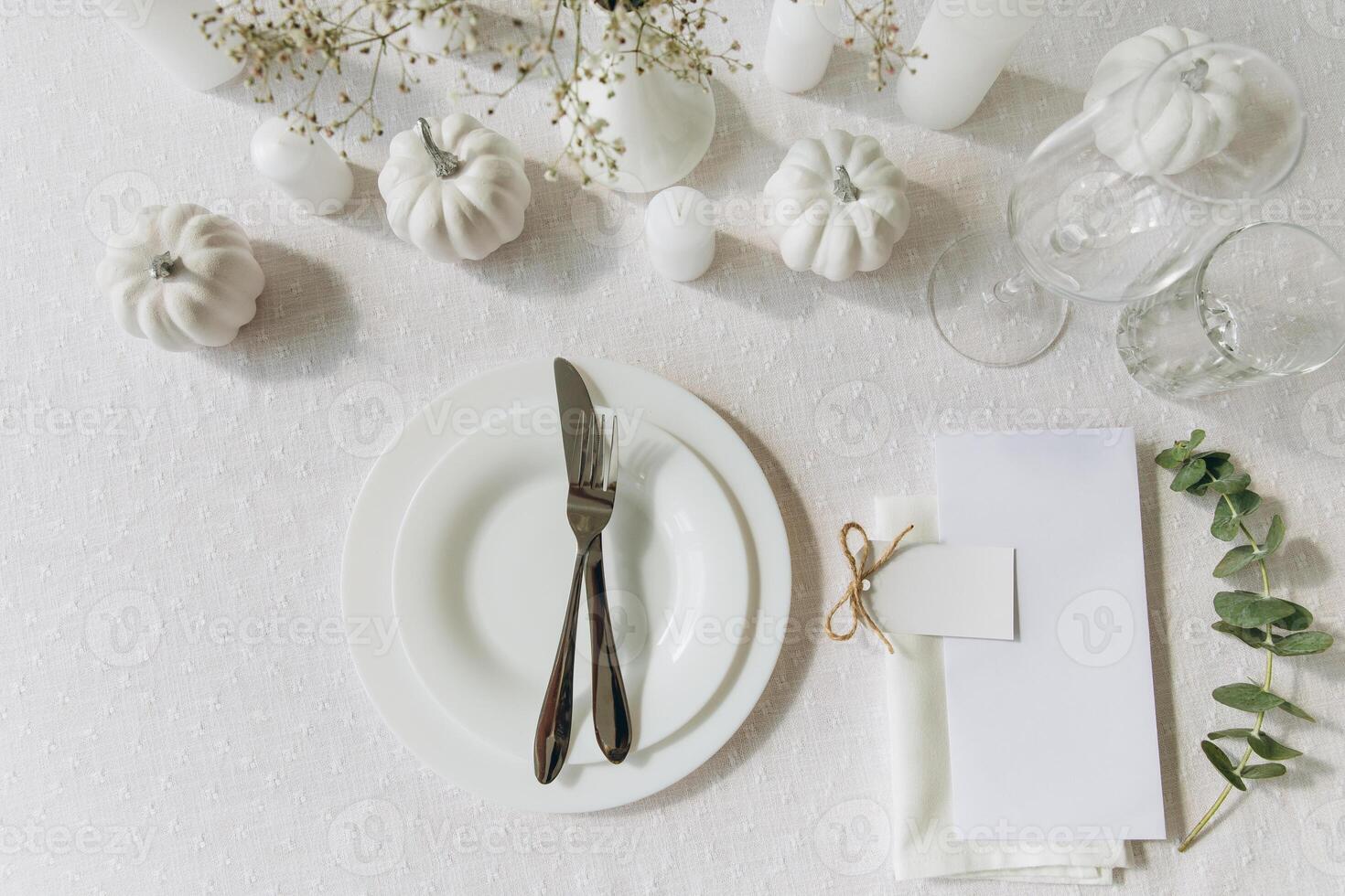 Thanksgiving table setting, tableware and decorations. Blank white postcard on table mockup, top view photo