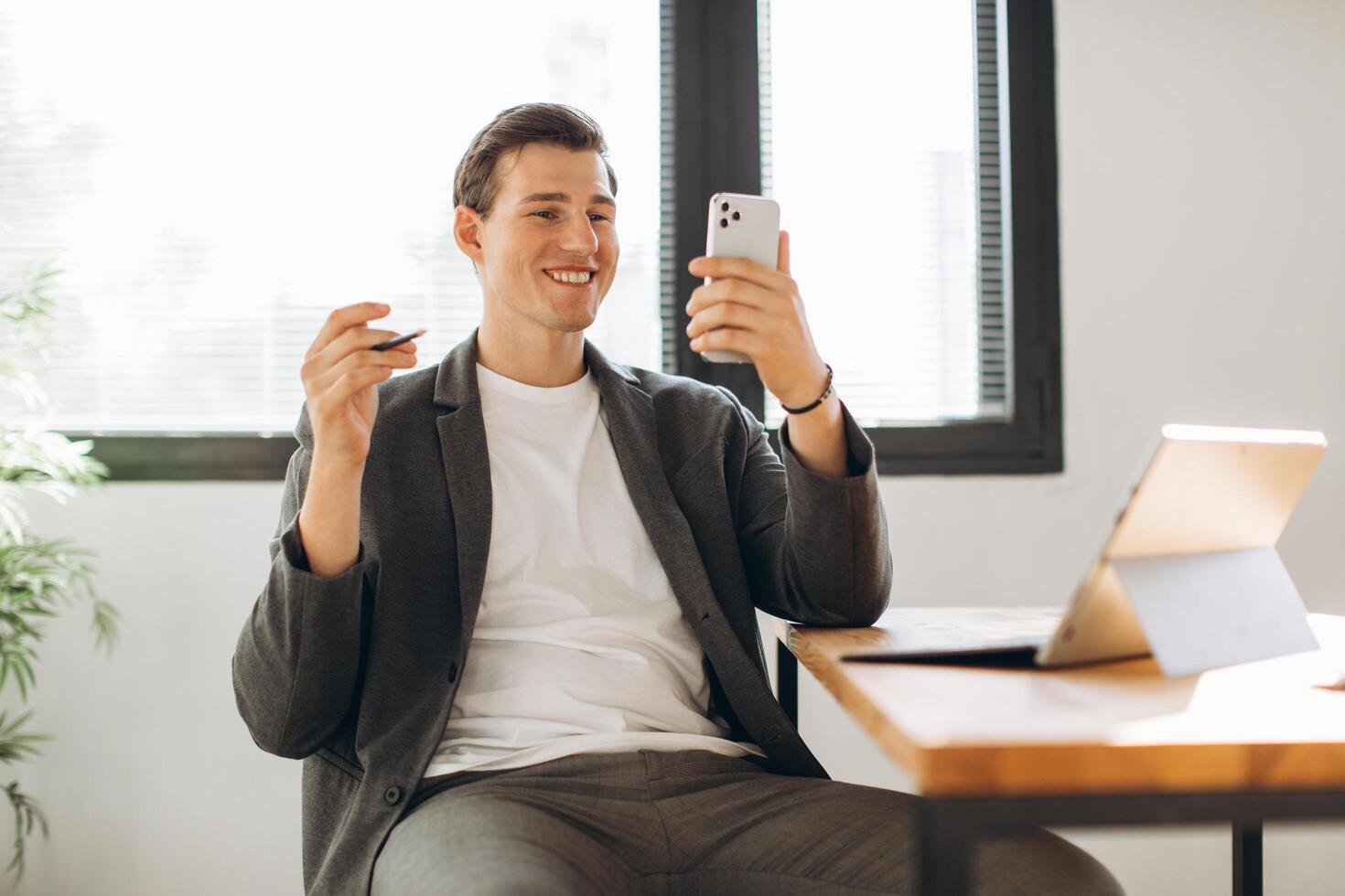 Modern smiling office worker has a call in the office photo