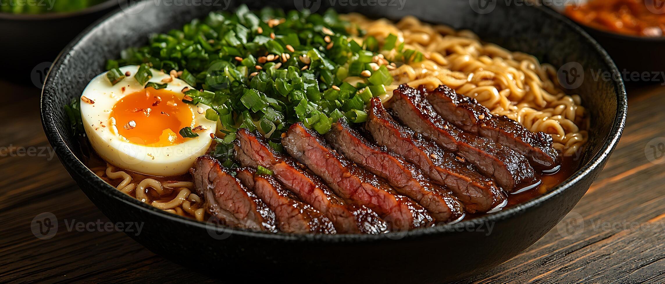 Close-up of a bowl of ramen noodles with beef, egg, and scallions. photo