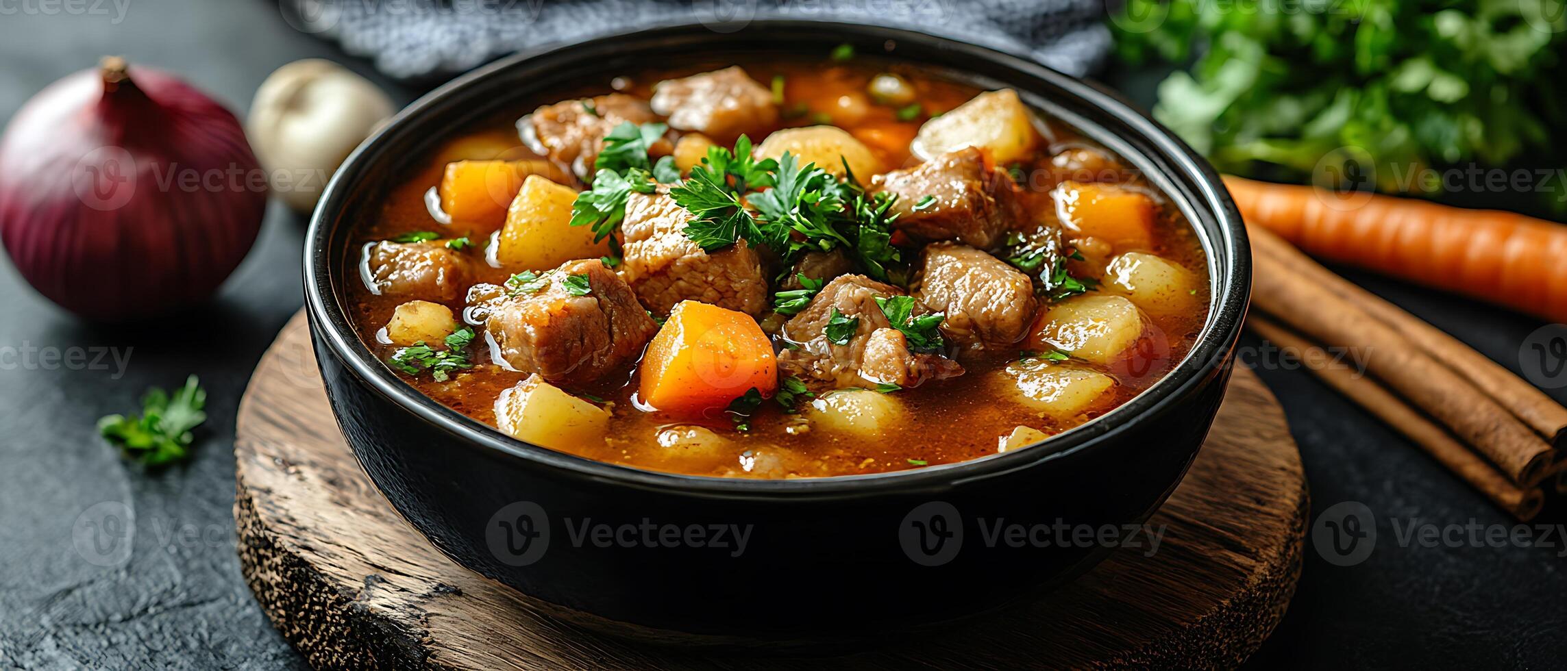 Close-up of a bowl of hearty beef stew with potatoes, carrots, and herbs. photo