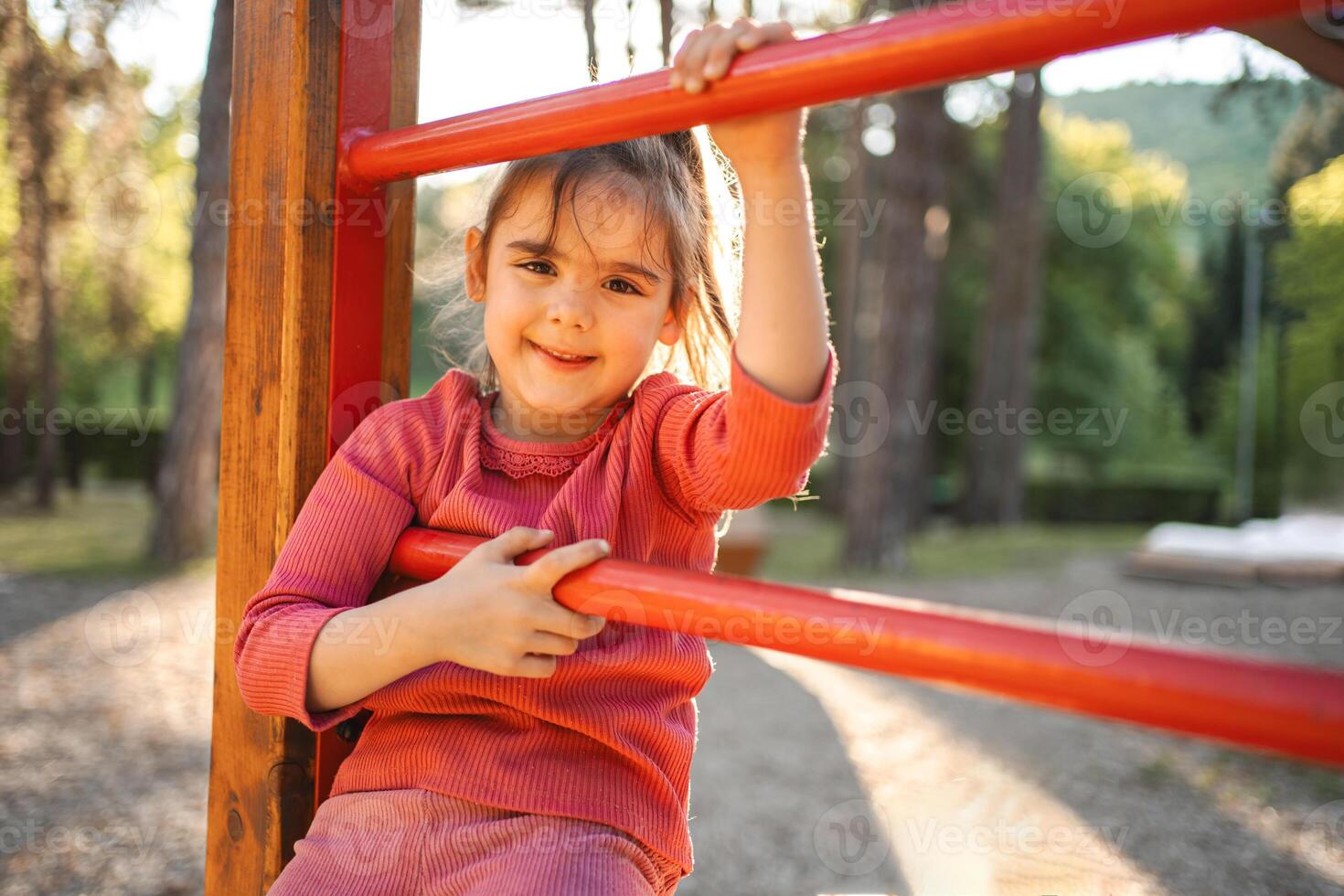 Active cute little girl on the playground photo