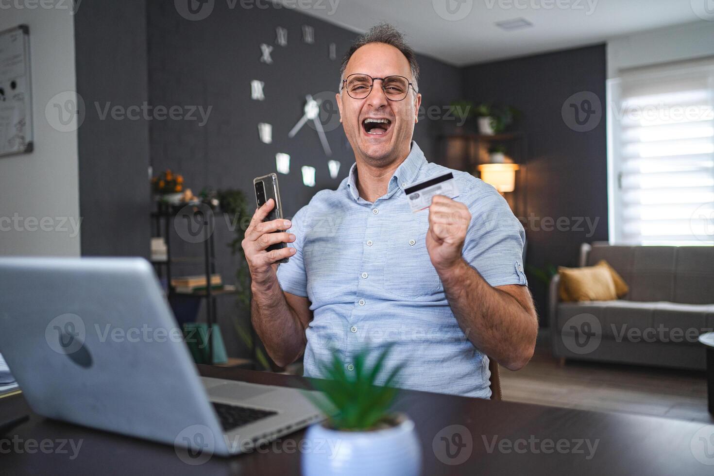 Middle aged Caucasian man online shopping at home photo