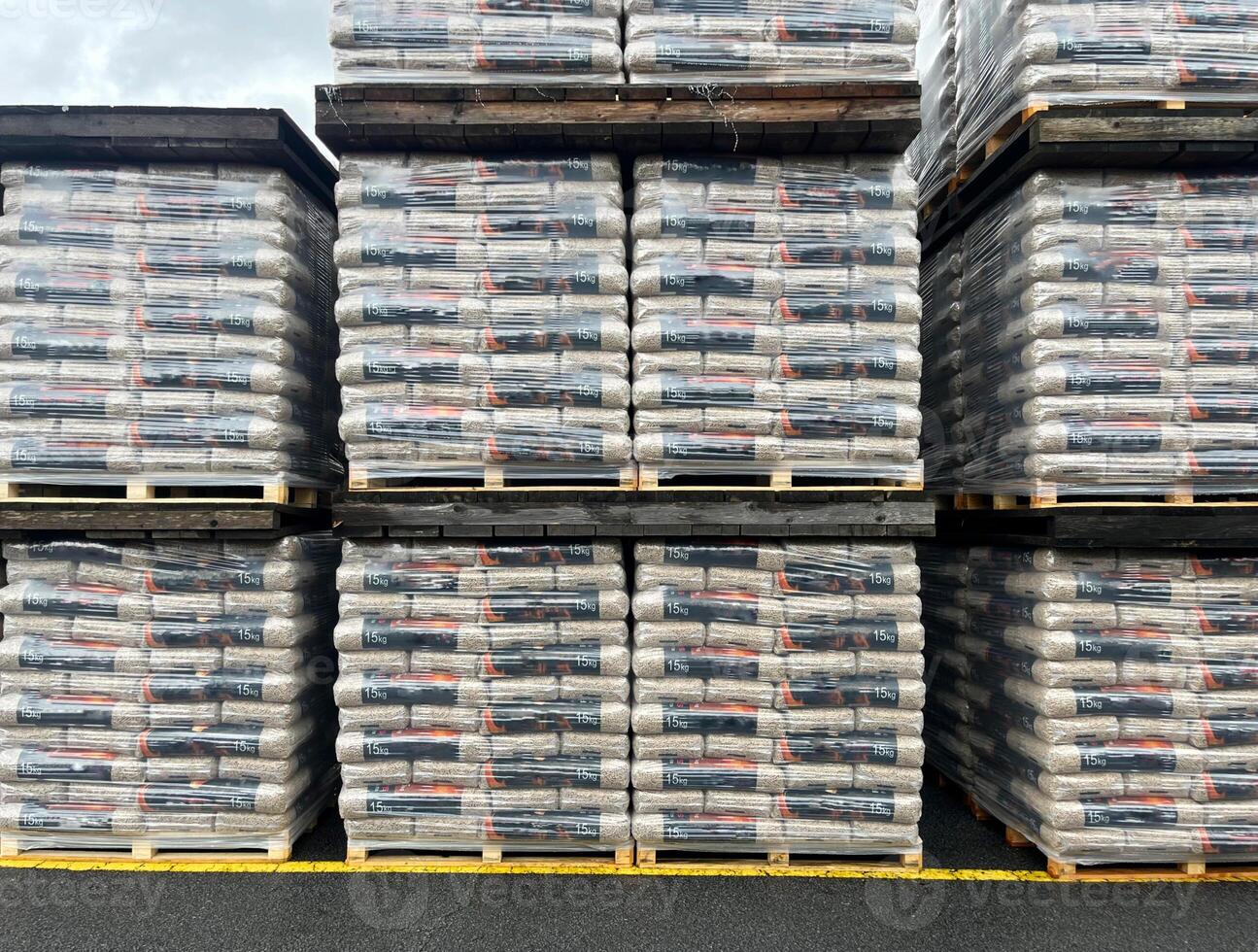 Warehouse with packed wooden pellets on pallets ready for shipment photo