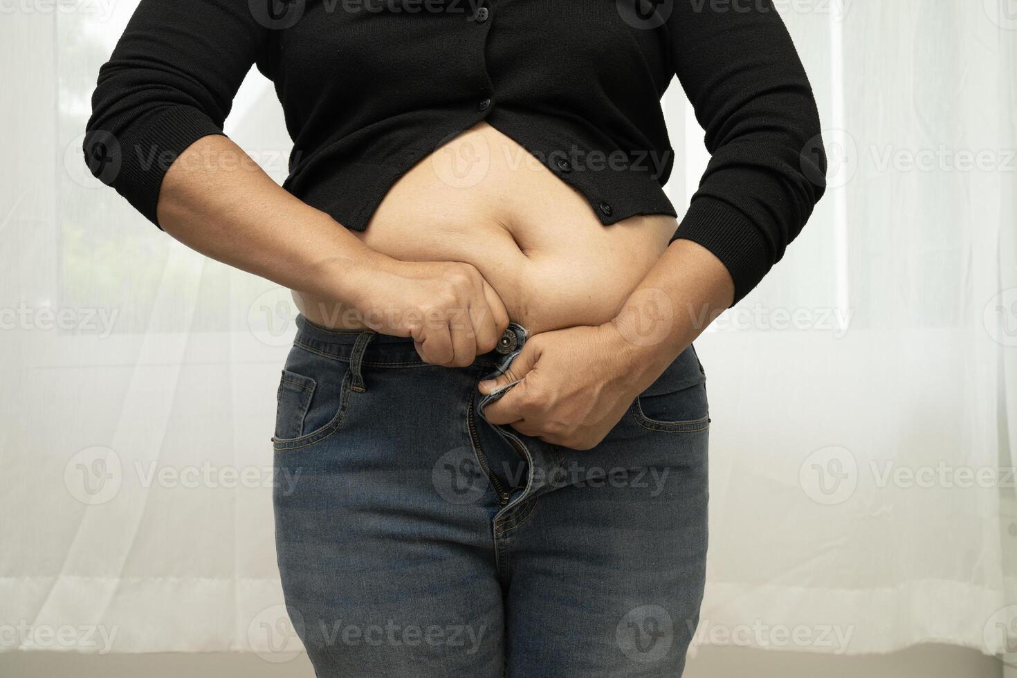 Asian woman show fat belly big size overweight and obesity isolated on white background with clipping path. photo