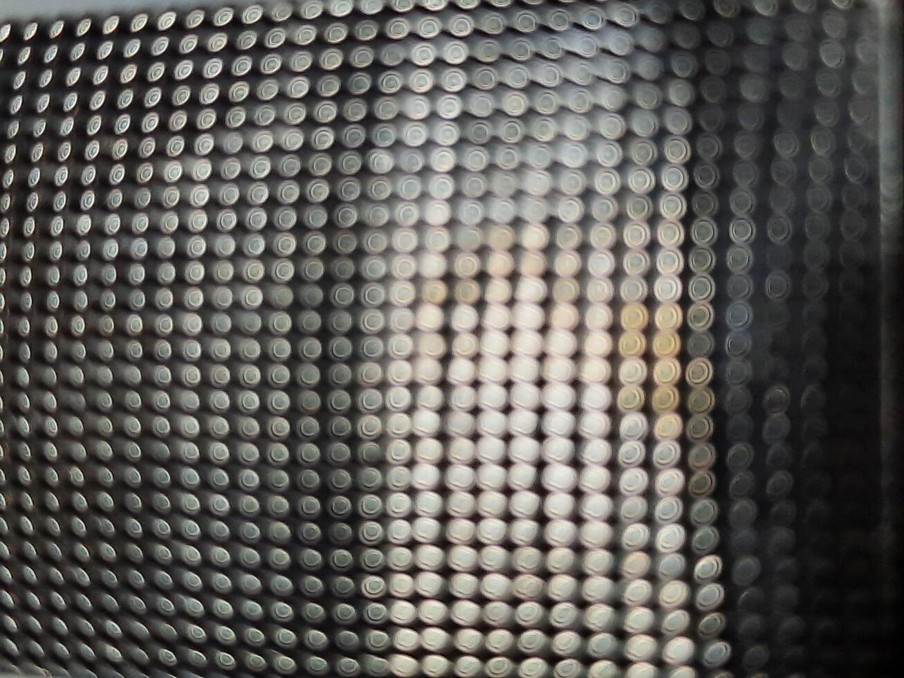 A close up of a metal mesh with dots photo